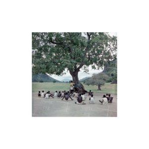 Nikolay Drachinsky. This Year the School Was Opened in Ilianari Setllement, Teacher Edidio Teaches Literacy to Kids Under the Big Tree. The Pupils Are Writing With Stilos on the Ground. South Sudan. 1957. The Photograph was published on the back cover of Ogonyok illustrated magazine, 1957, # 28, July. © Nikolay Drachinsky archive, courtesy of Alla Vakhromeeva, Archive Paper 8"x8", $400