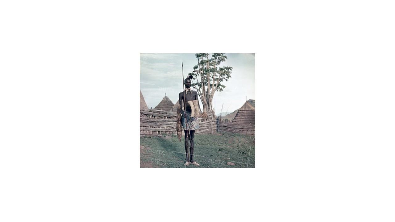 Nikolay Drachinsky. Warrior From Dinka Tribe Near the Border of His Settlement. Area of the City Al Manaqil, Upper Nile Province. Sudan, 1957. © Nikolay Drachinsky archive, courtesy of Alla Vakhromeeva, Archive Paper 14"x14", $500