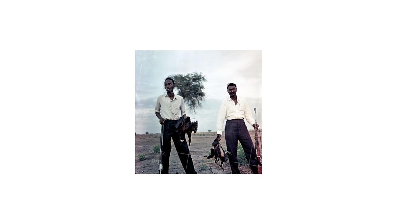 Nikolay Drachinsky. Governor’s Managers Roduan and Cambel After Successful Hunting Nearby Settlement of Dinka Tribe. Area of the City Al Manaqil, Upper Nile Province. Sudan, 1957. © Nikolay Drachinsky archive, courtesy of Alla Vakhromeeva, Archive Paper 14"x14", $500